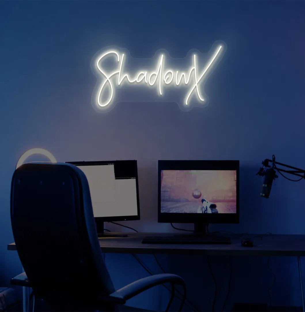 Image of a stylish personalized gamer tag neon sign mounted on decorative wall in warm white color.