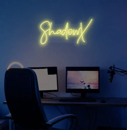 Image of a stylish personalized gamer tag neon sign mounted on decorative wall in yellow color.