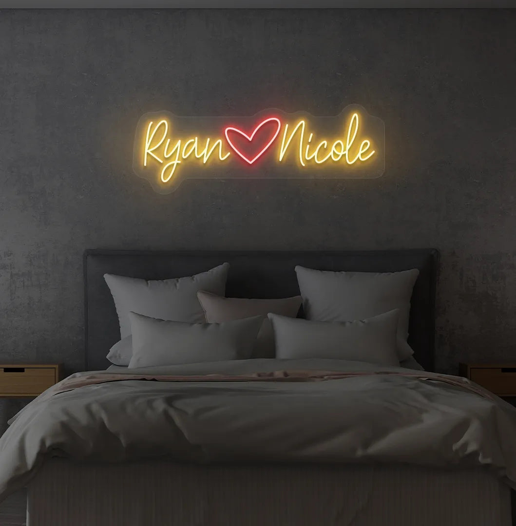 Personalized orange LED name sign mounted on modern bedroom wall.