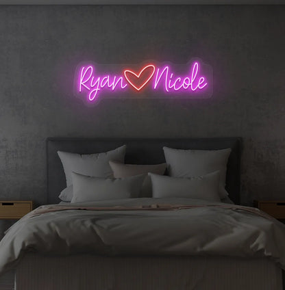 Custom Name neon sign with heart icon in pink color on modern wall.