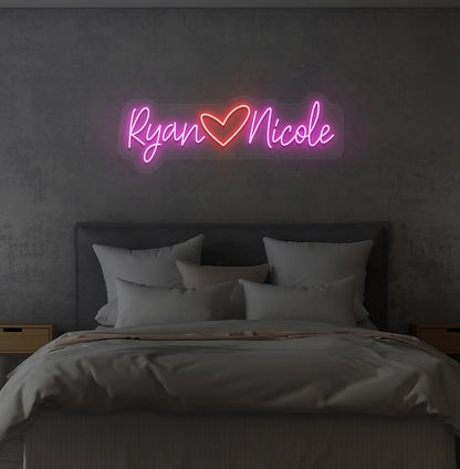Personalized purple LED name sign mounted on modern bedroom wall.