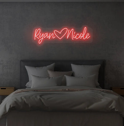 Custom Name neon sign with heart icon in red color on modern wall.