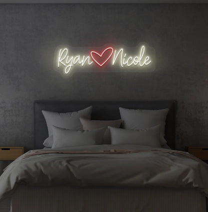Personalized warm white LED name sign mounted on modern bedroom wall.