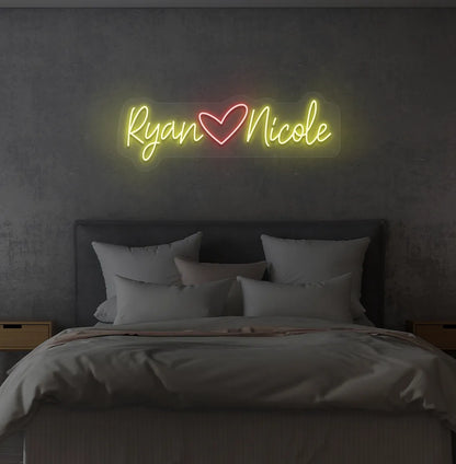 Personalized yellow LED name sign mounted on modern bedroom wall.
