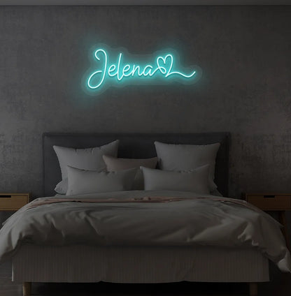 Personalized Name with Heart neon sign in ice blue color mounted on modern wall.
