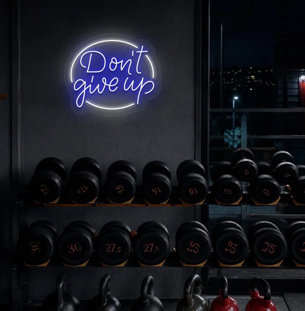 Image of an Aesthetic gym wall with "don't give up" neon sign glowing blue.