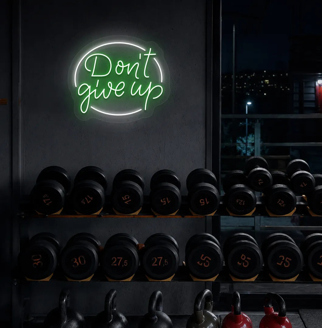 Green "don't give up" LED neon sign for workout room wall setup.