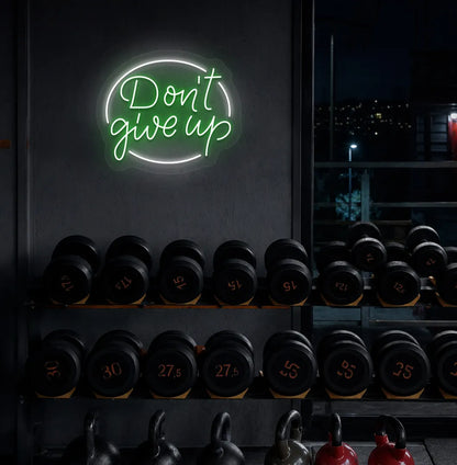 Green "don't give up" LED neon sign for workout room wall setup.