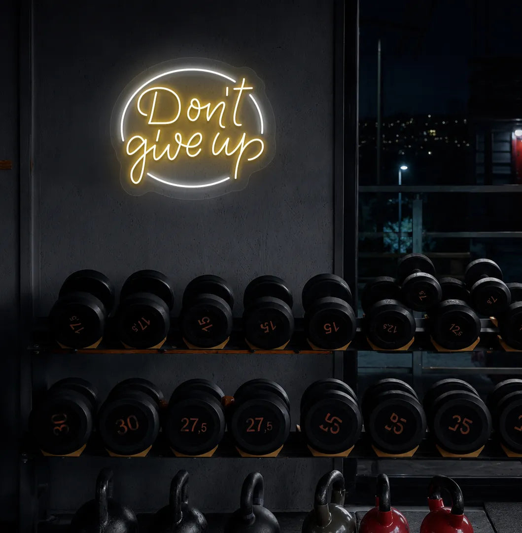 Orange "don't give up" LED neon sign for workout room wall setup.