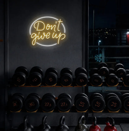 Orange "don't give up" LED neon sign for workout room wall setup.