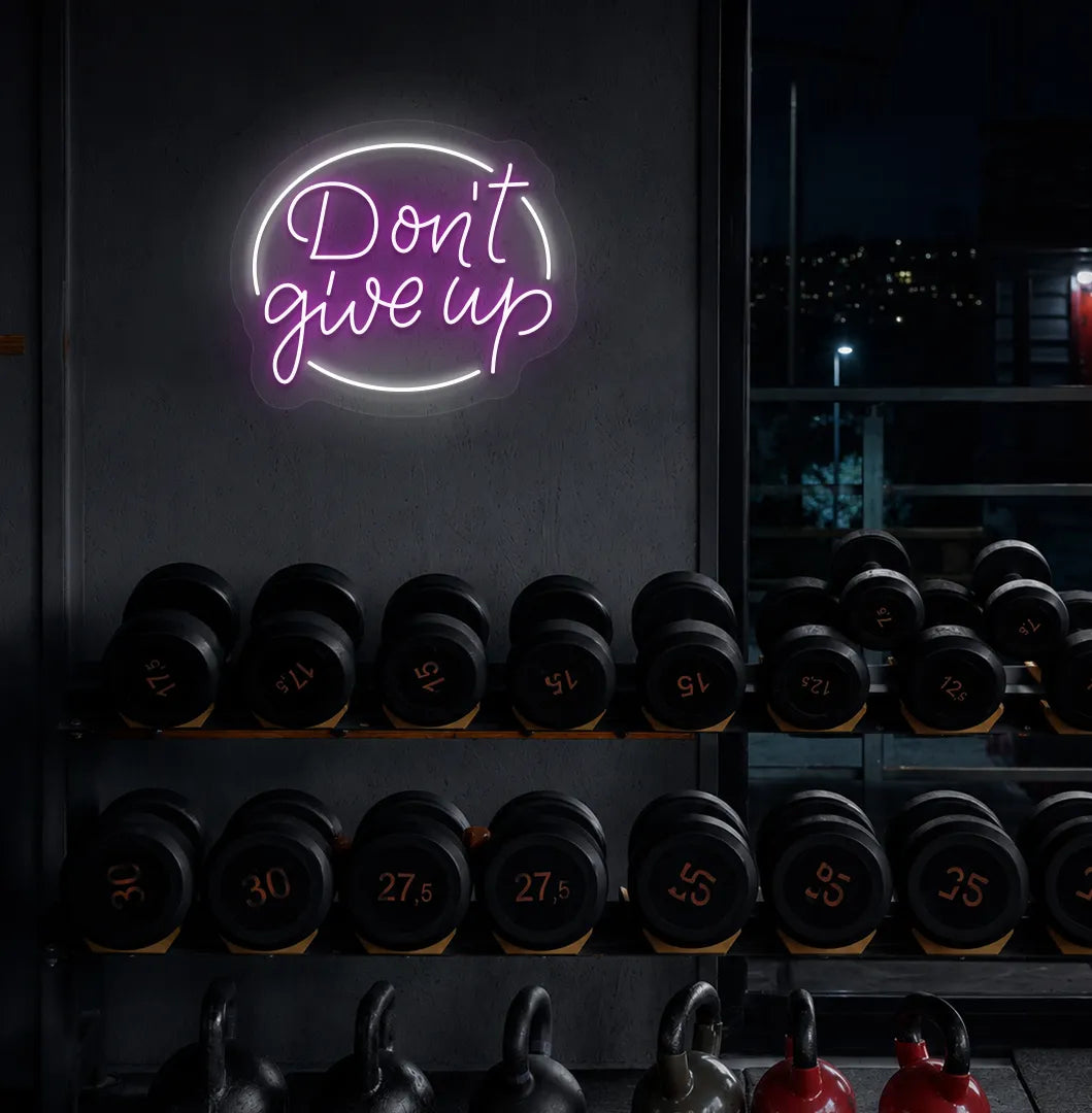 Purple "don't give up" LED neon sign for workout room wall setup.