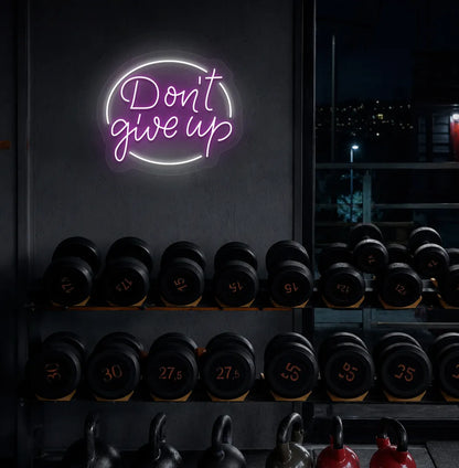 Purple "don't give up" LED neon sign for workout room wall setup.