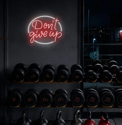 Image of an Aesthetic gym wall with "don't give up" neon sign glowing red.