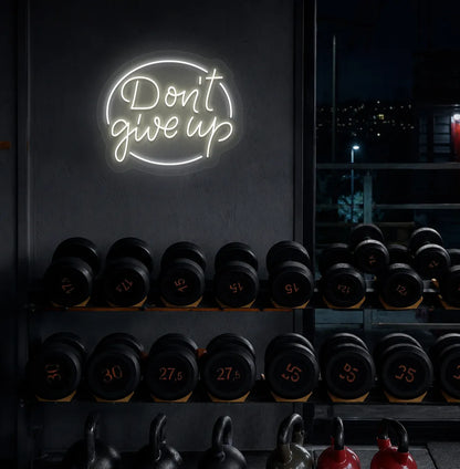 Warm white "don't give up" LED neon sign for workout room wall setup.