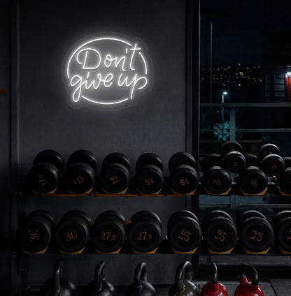 Image of an Aesthetic gym wall with "don't give up" neon sign glowing white.