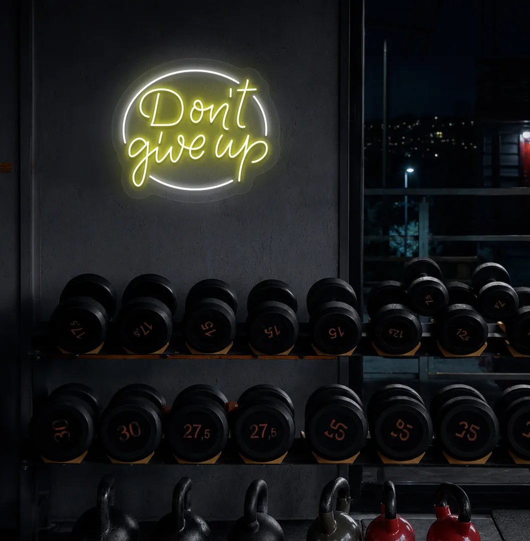 Yellow "don't give up" LED neon sign for workout room wall setup.