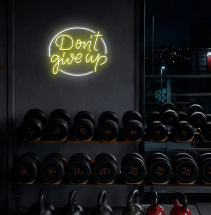 Yellow "don't give up" LED neon sign for workout room wall setup.