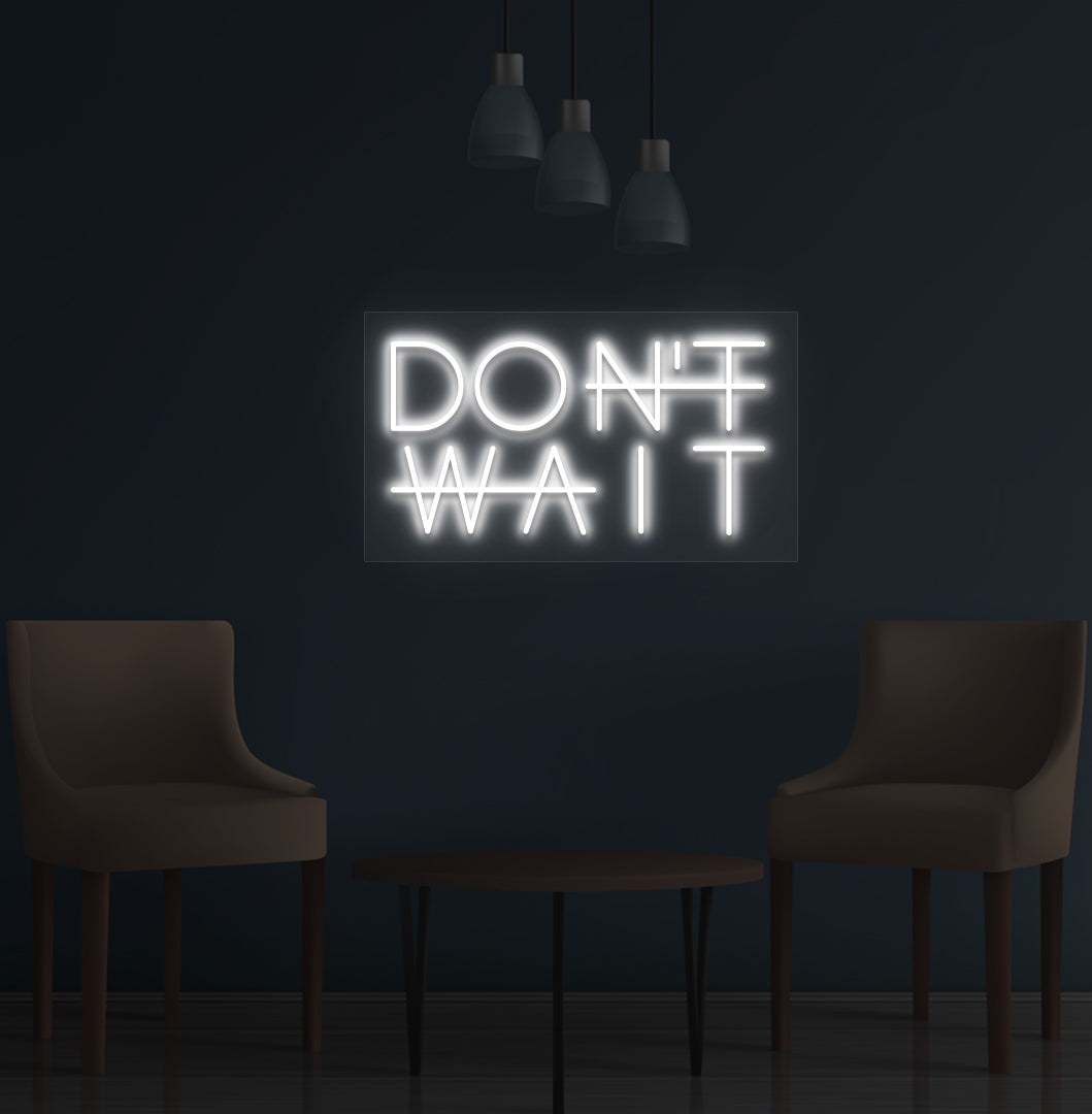 Image of a motivational "Don't Wait" LED neon sign mounted on a wall in white color.