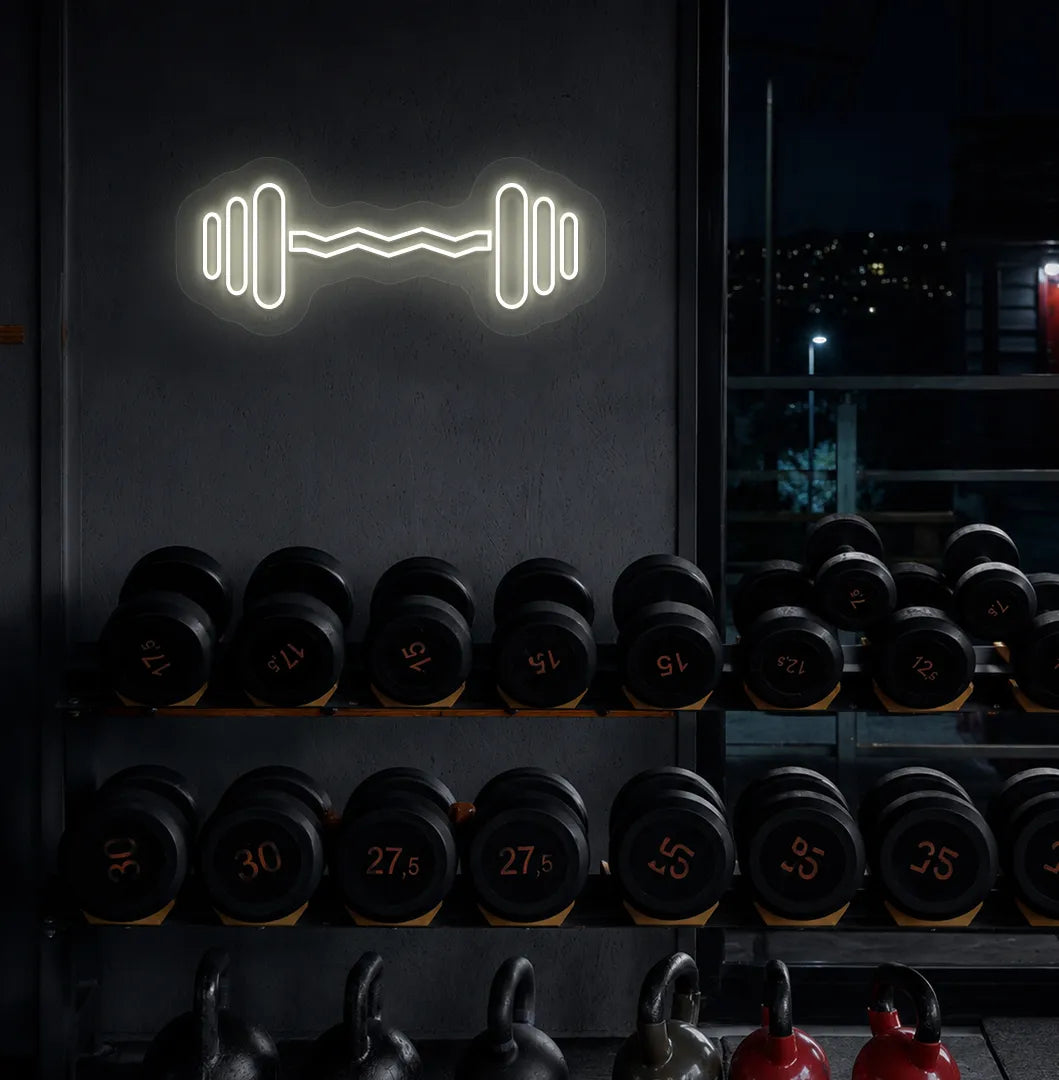 Trendy dumbbell neon sign in warm white mounted on fitness wall.