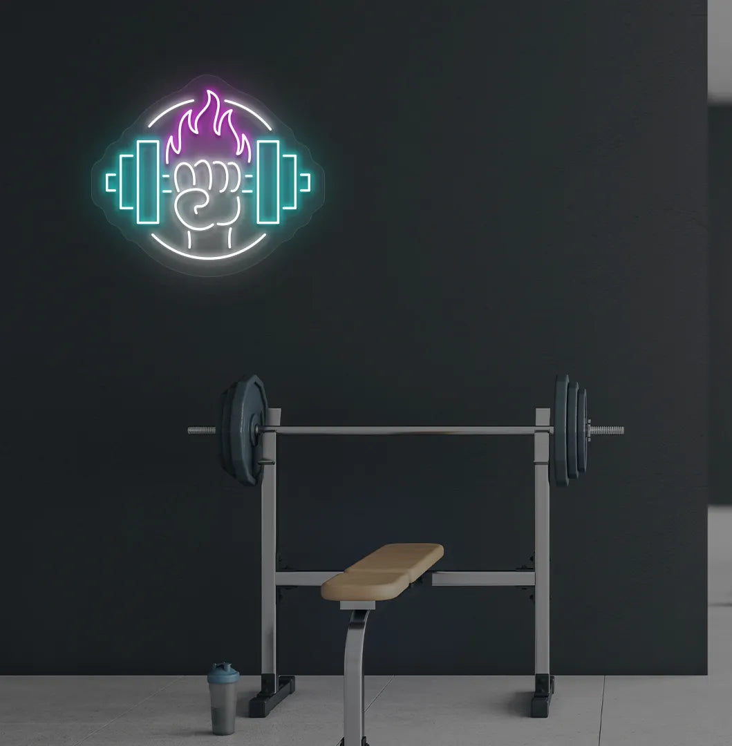 Image of a "Dumbbell in hand" neon sign in pink color mounted on gym wall.