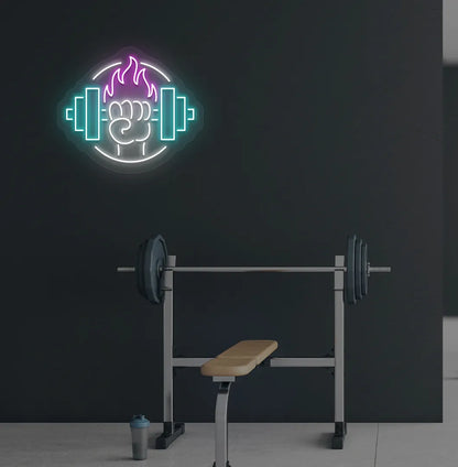 Image of a "Dumbbell in hand" neon sign in pink color mounted on gym wall.