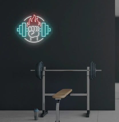 Image of a "Dumbbell in hand" neon sign in red color mounted on gym wall.
