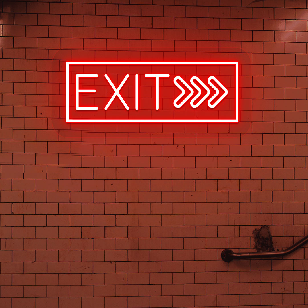 Directional red LED exit neon sign hanging on the brick design wall.