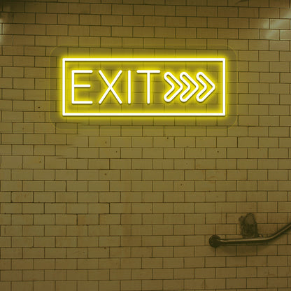 Image of an exit LED neon sign glowing on a brick-patterned wall in yellow.