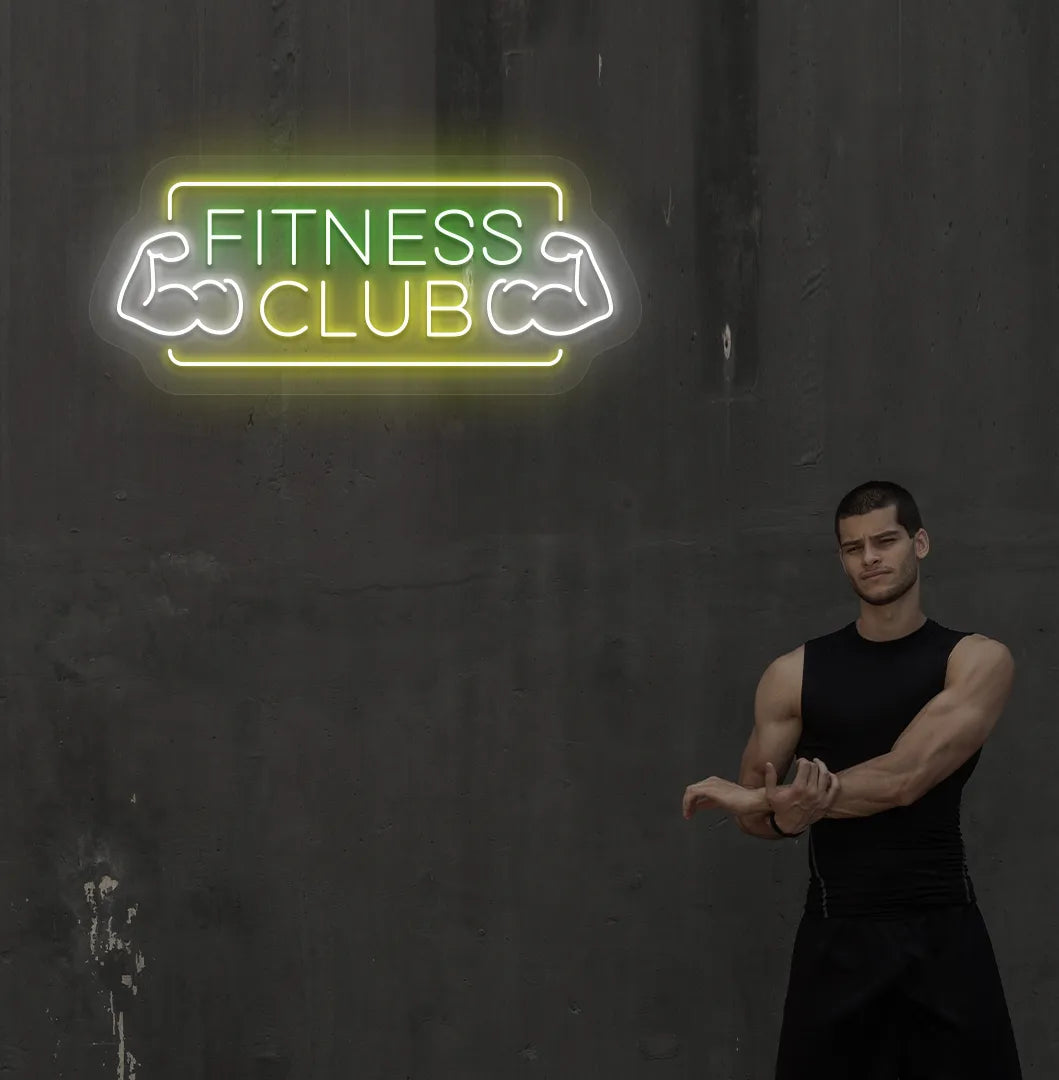 Stylish fitness club neon sign in green mounted on gym wall.