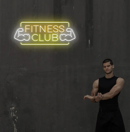 Stylish fitness club neon sign in orange mounted on gym wall.
