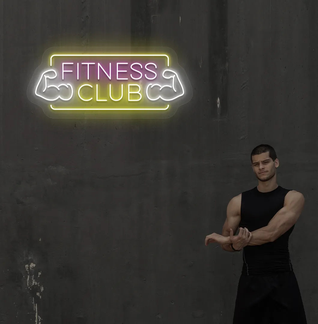 Stylish fitness club neon sign in purple mounted on gym wall.
