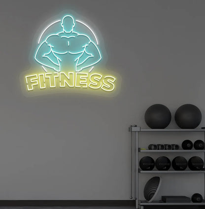 Trendy fitness neon sign in yellow mounted on fitness wall.
