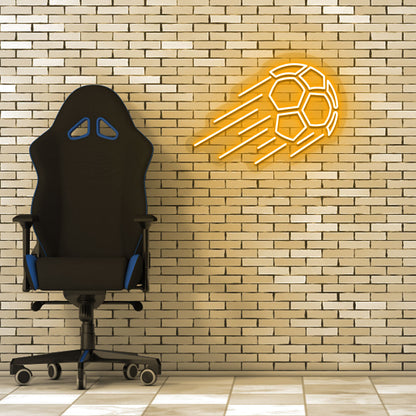 Game room decor with an orange flying football neon sign on a brick wall and a chair.