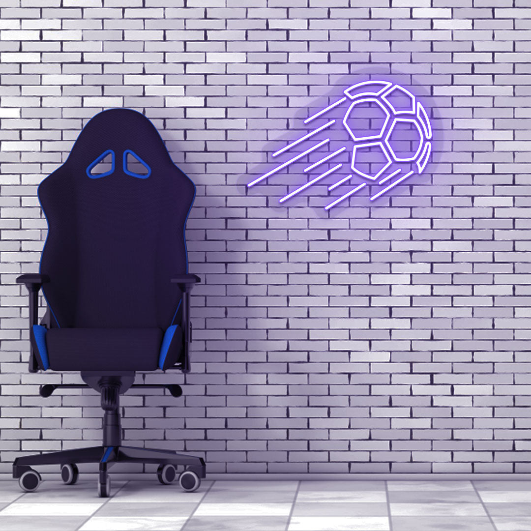 Game room decor with a purple flying football neon sign on a brick wall and a chair.