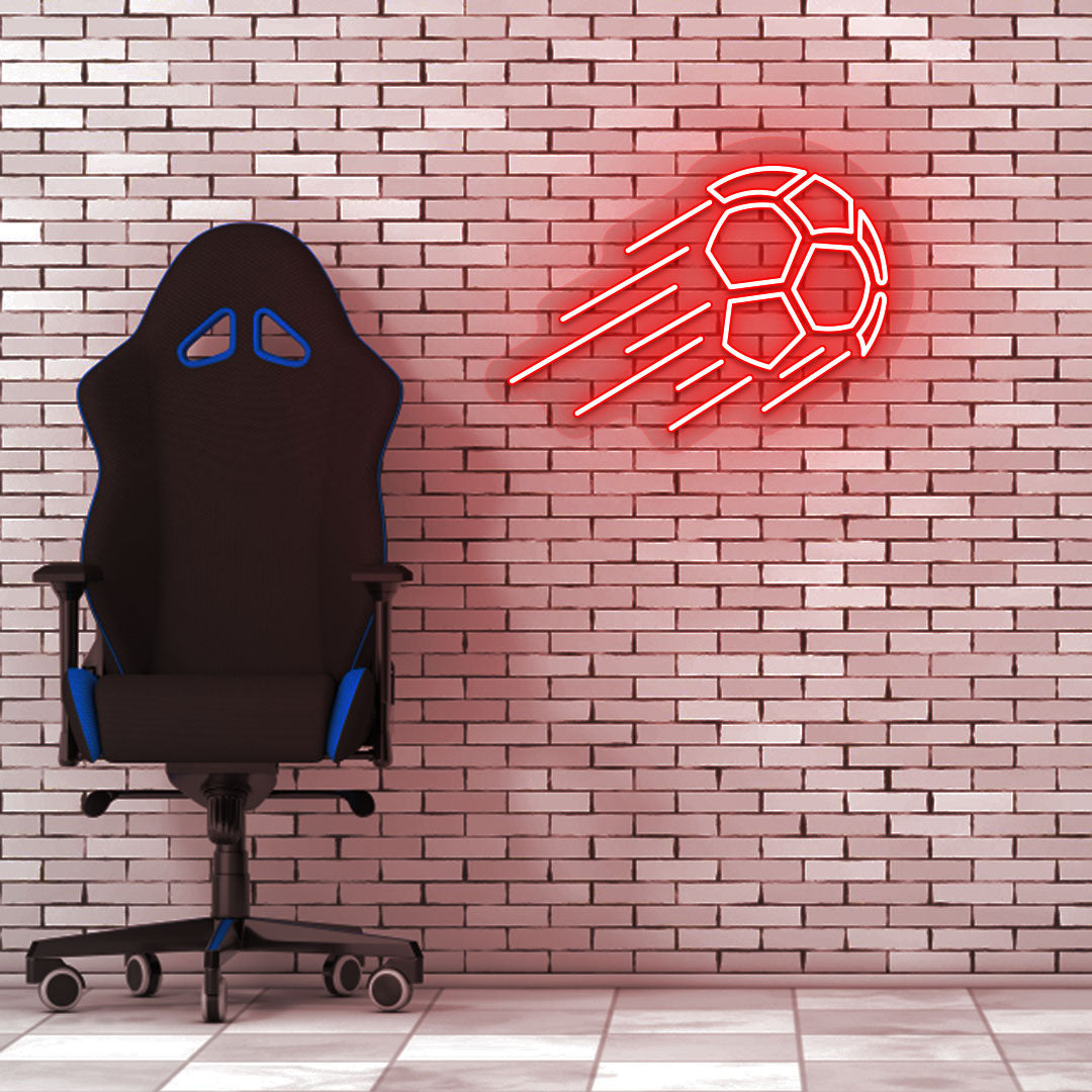 Image of a flying football neon sign in red LED on a brick design wall with a chair setup.