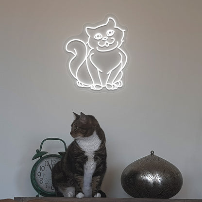 A stylish white cat LED neon sign above a cute cat is mounted on the wall. Perfect for pet lovers, bedroom, living room décor, and kids’ rooms.