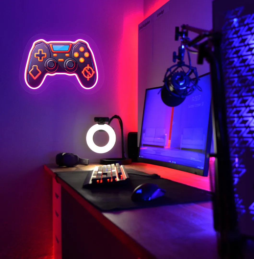 Image of a "Game controller" neon sign in pink color mounted on gaming room wall.