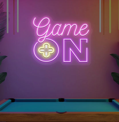 Image of a "game on" LED neon sign glowing on an aesthetic wall in pink.