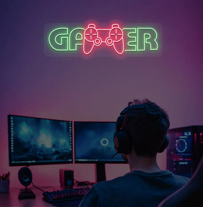 Trendy Gamer neon sign mounted on entertainment room wall in green color.