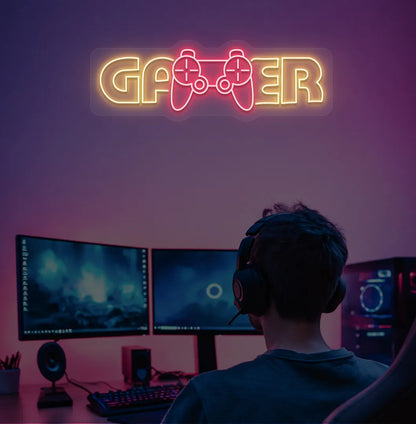 Trendy Gamer neon sign mounted on entertainment room wall in orange color.