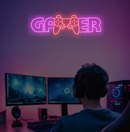 Image of a gamer neon sign mounted on gaming room wall in pink color.