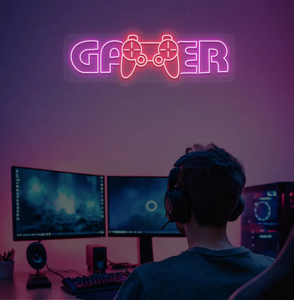 Trendy Gamer neon sign mounted on entertainment room wall in pink color.