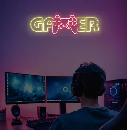 Trendy Gamer neon sign mounted on entertainment room wall in yellow color.