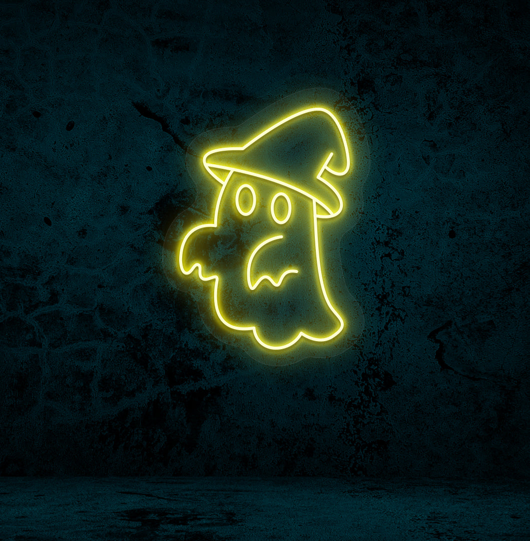 Halloween wall with "ghost with hat" neon sign glowing yellow.