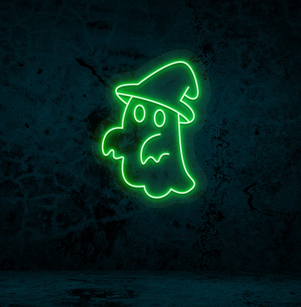 Halloween wall with "ghost with hat" neon sign glowing green.