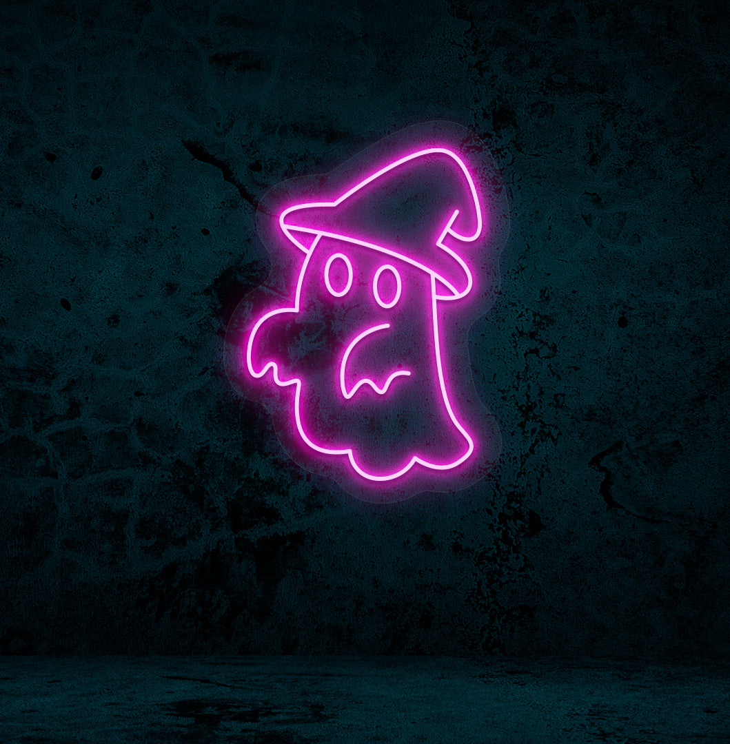 Image of a ghost with hat neon sign glowing on a wall in pink color.