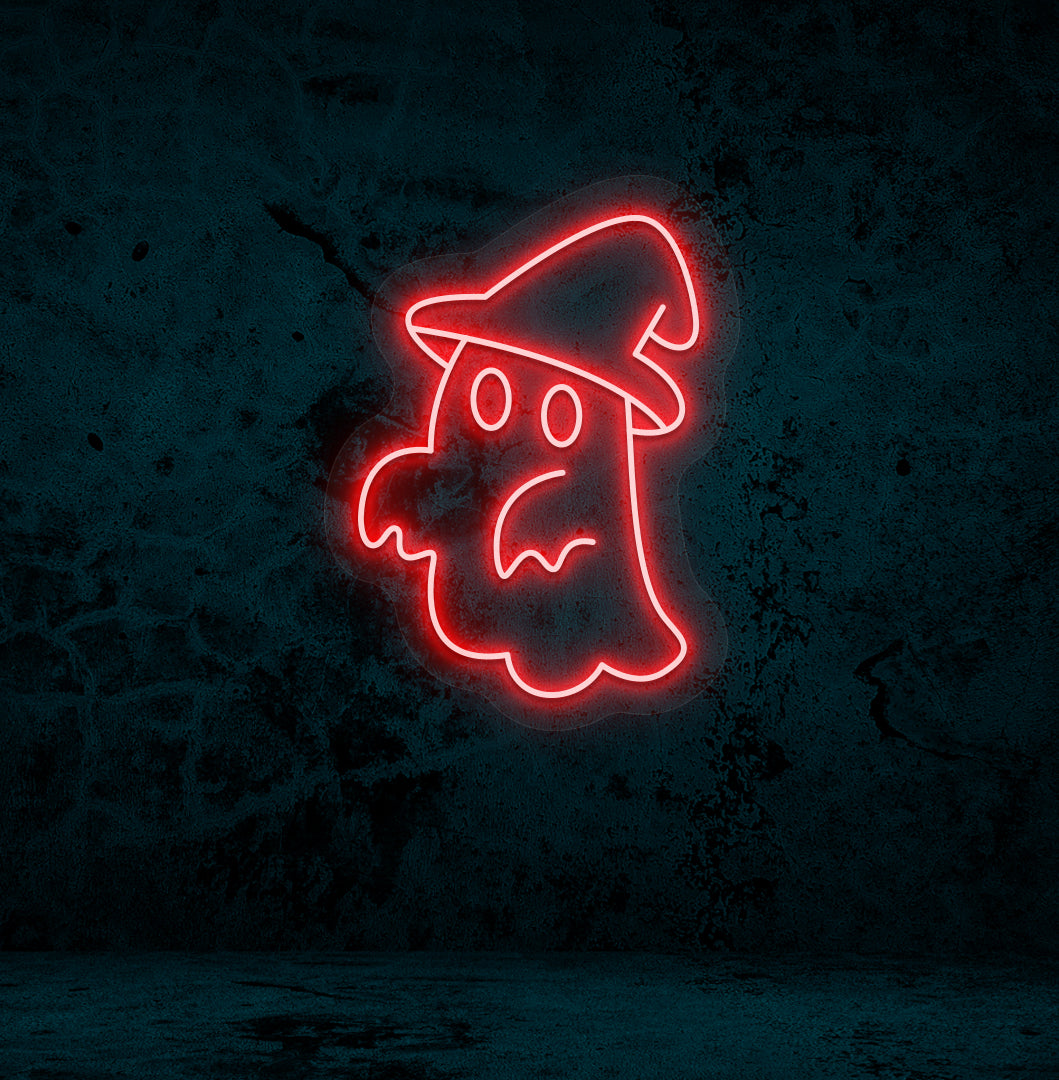 Image of a ghost with hat neon sign glowing on a wall in red color.