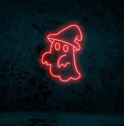 Image of a ghost with hat neon sign glowing on a wall in red color.