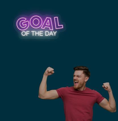 Image of a modern sports wall decor with goal of the day neon sign glowing pink.