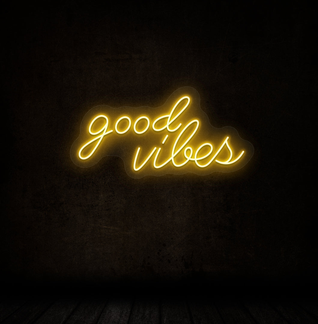 A stylish orange LED "good vibes" neon sign mounted on a dark wall. Perfect for bedrooms, gaming, streaming setups, and cafés.